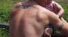 Tribal arm band and upper back - Extending the upper back TAT tattoo