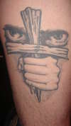 Evil behind cross tattoo