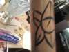 Left side of flower on staf tattoo