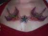 chest piece of swallows and nautical star tattoo