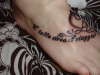 Italian phrase and profile of a horsehead tattoo