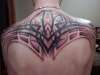 Tribal back piece with initials tattoo
