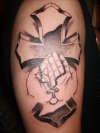 the classic cross with hands tattoo