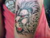 lion with skulls in hair tattoo