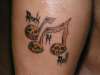 Music notes skulls tattoo