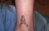 Cancer awareness ribbon tattoo