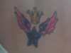Wings, star and crown tattoo
