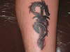 Dragon wrapped around a sword tattoo