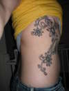 Daisy side rib tat tattoo
