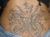 BITTERFLY TRAPPED ON WEB WITH HEARTS tattoo