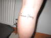 Forever young text left leg tattoo