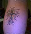 Sun, cross and treble clef tattoo
