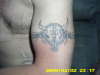 dull skull and band tattoo