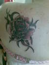 rose on back tattoo