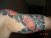 Red Flower under arm tattoo