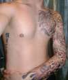 Full sleeve into the chest tattoo