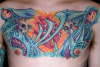 biomech chest piece tattoo
