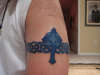 Cross on celtic band tattoo