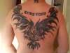 Tribal phoenix and latin writing tattoo
