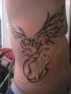 Tribal phoenix on ribcage tattoo