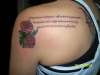 roses with greek writing on back tattoo