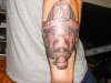 Firefighter face back of forearm tattoo