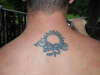 Sun and dragon tribal tattoo