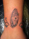 tiny praying hands tattoo